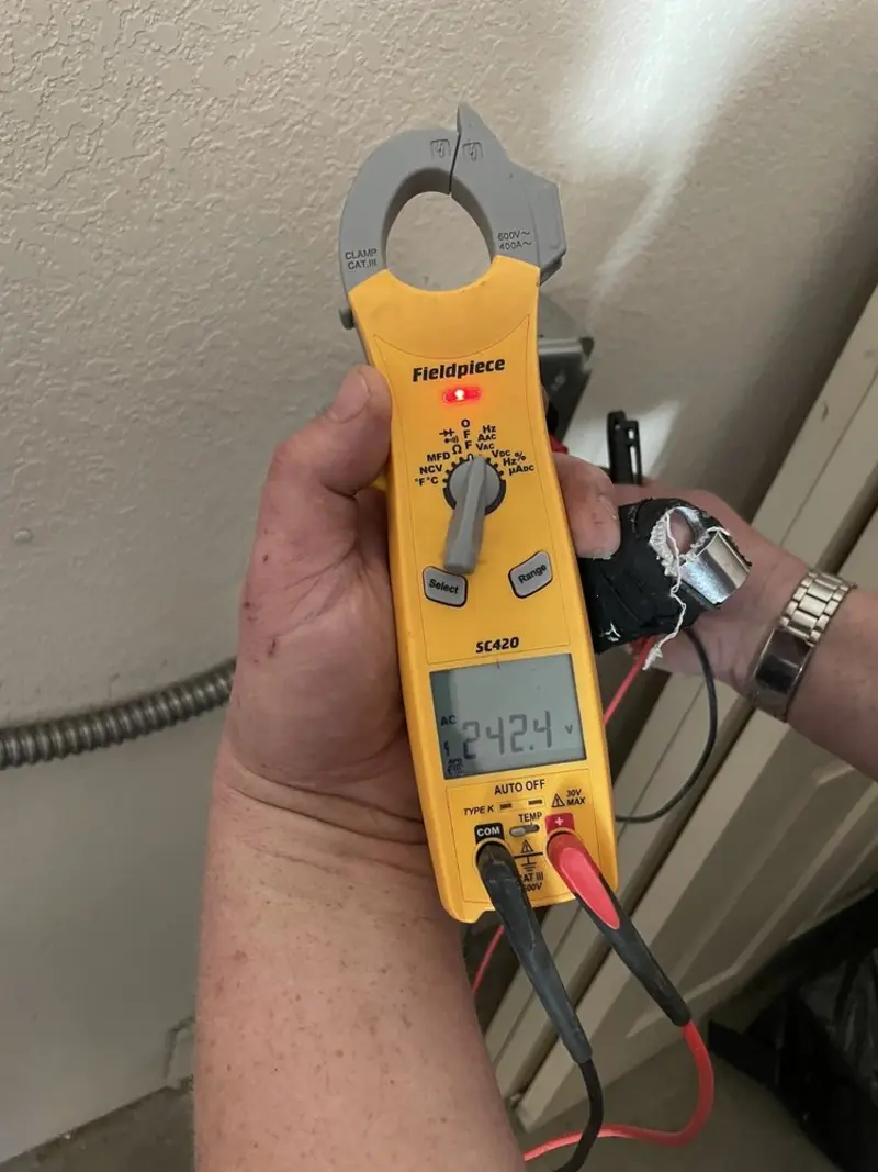 Voltage testing with clamp meter during Outlet Installation in Barboursville